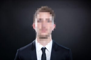 a man in a suit with a pixelated face