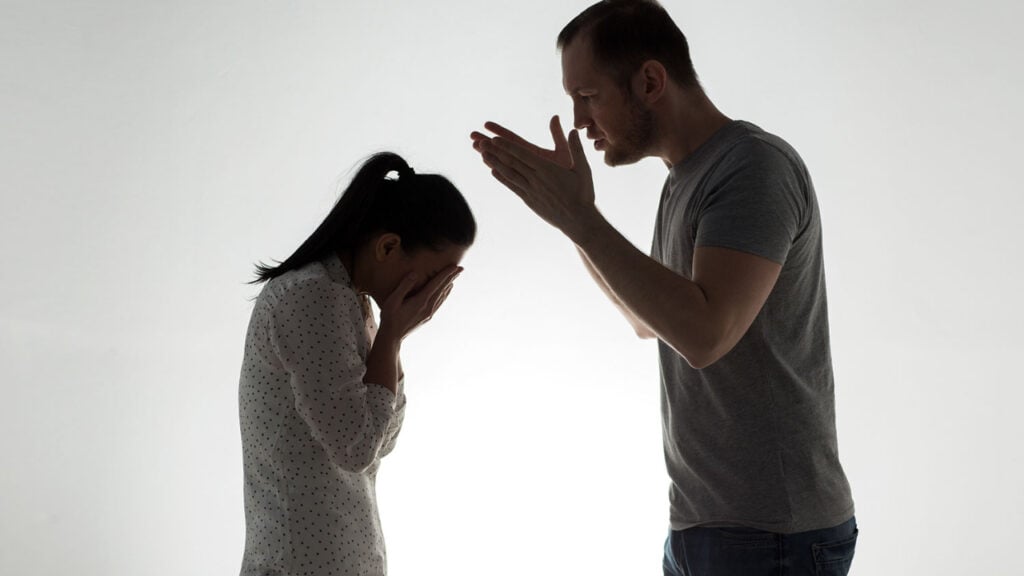 What Is Narcissistic Projection and How Do Narcissists Use It? 1 a man leaning over a woman with her head in her hands. Projecting blame onto her
