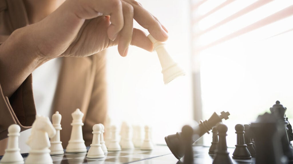 Why Do People Gaslight? 1 a hand moving chess pieces