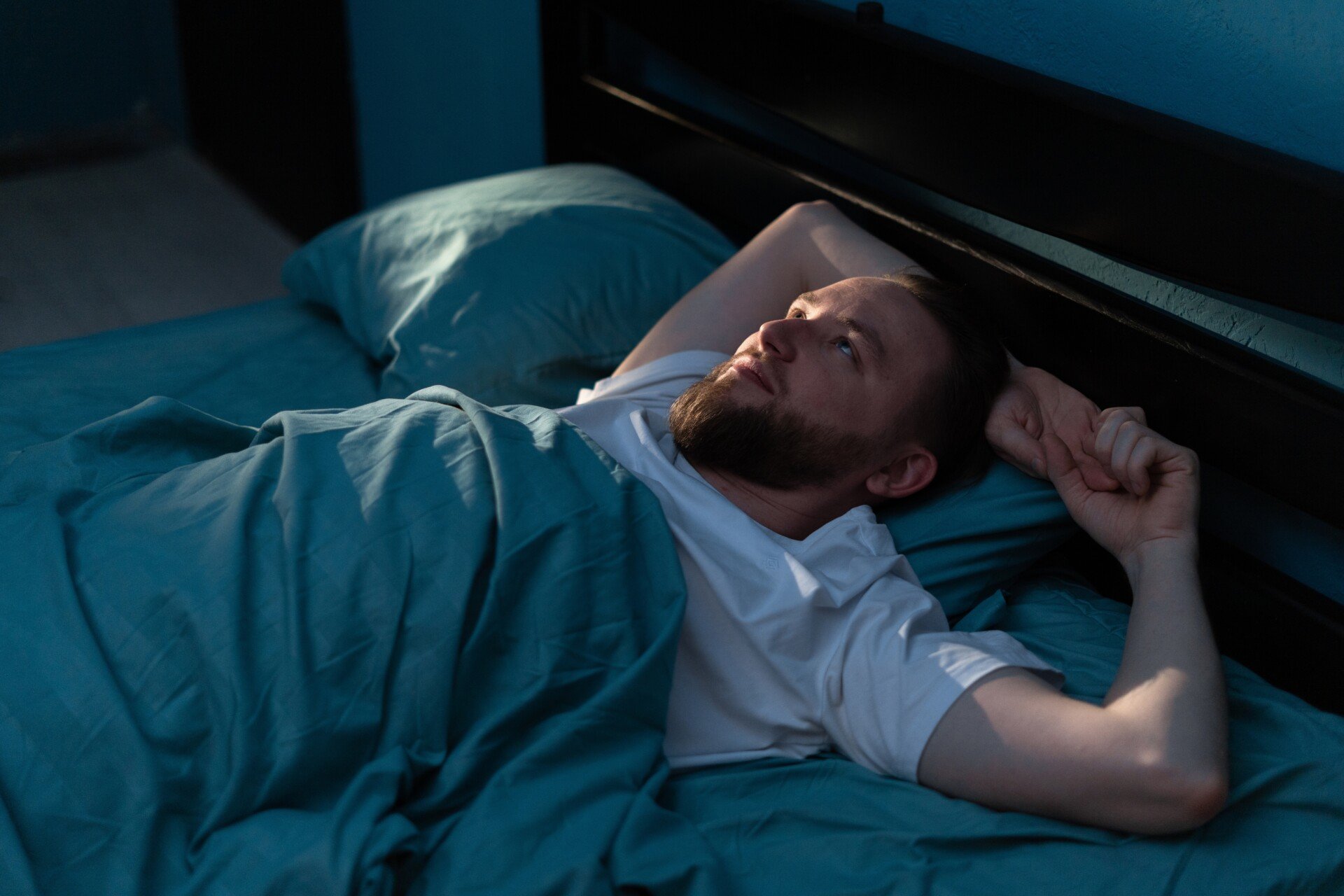 Anxious Man Anxious man lay in bed looking at ceiling.