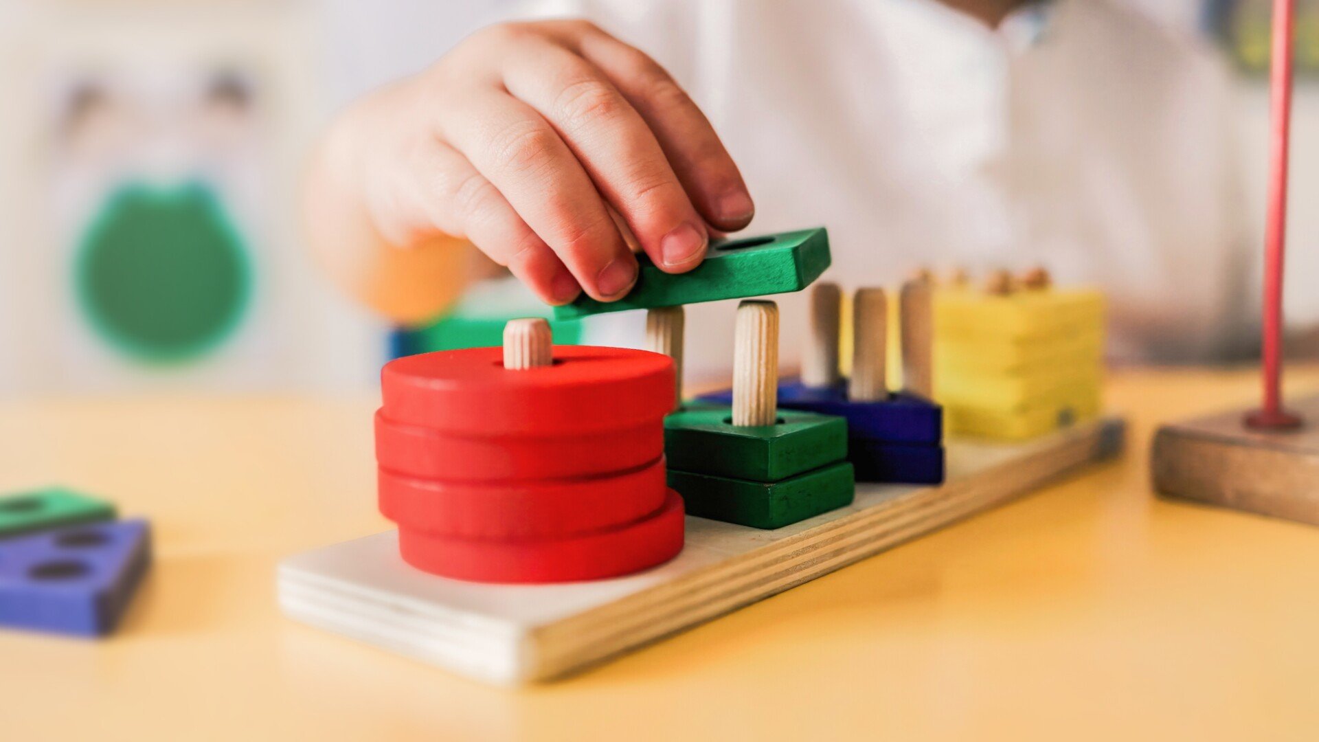 Child Toy Close up of a child hands playing with a stacking toy game.
