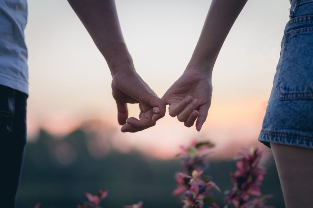 What Is The Most Common Love Language? 3 couple holding pinky fingers