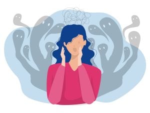 A fearful woman surrounded by lingering ghostly figures.