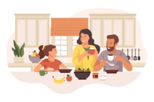 Parents and a child happily having breakfast together at the kitchen table
