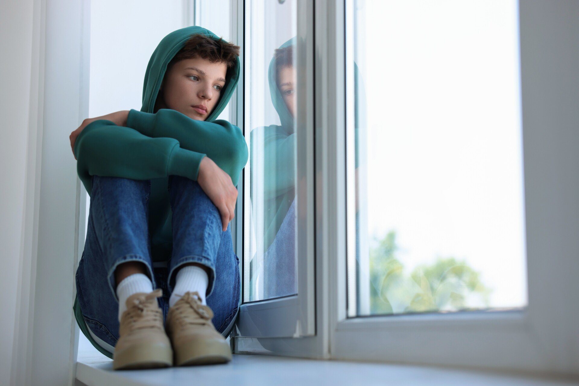 Loneliness,Concept.,Sad,Teenage,Boy,On,Windowsill,Indoors lonely teenager