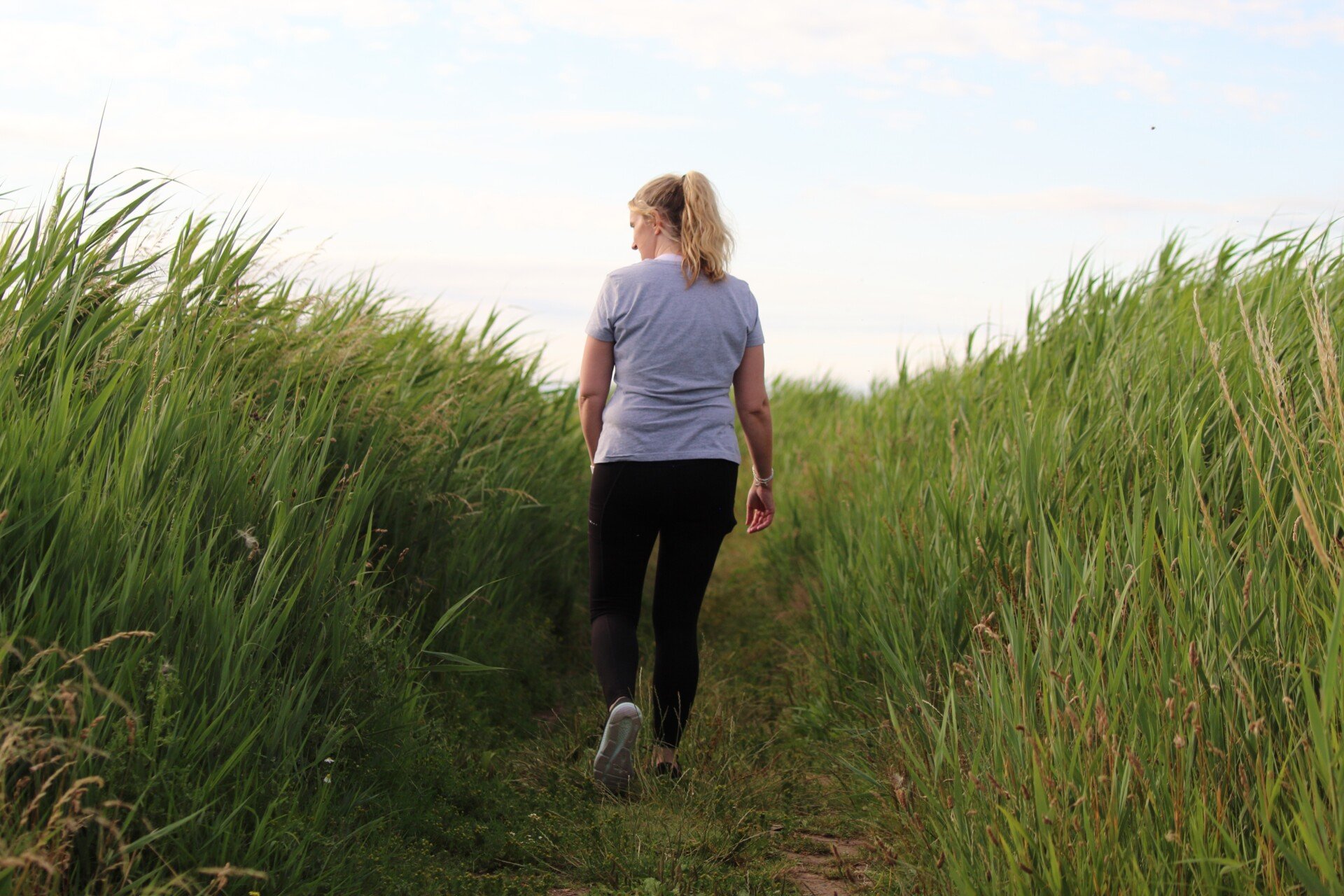 Nature Walk A woman walking through a field