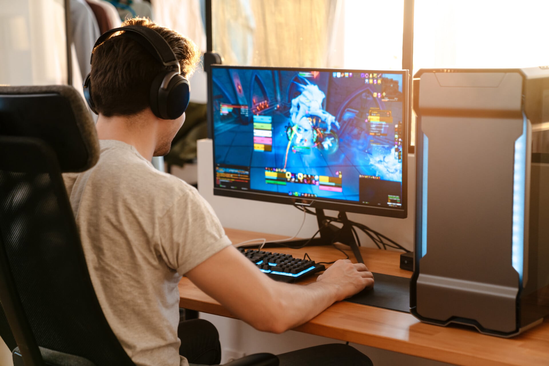Online Gaming a man playing an online game at a desk with headphones on