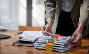 Close-up of someone organising their colour-coded files on a desk.